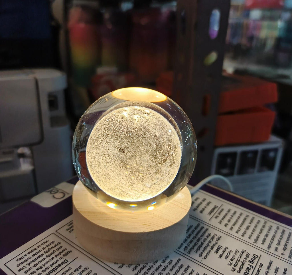 Beautiful 3D Crystal Ball LED Table Lamp With Laser Engraved Solar System Or Galaxy Design On Wooden Base (Random Design)