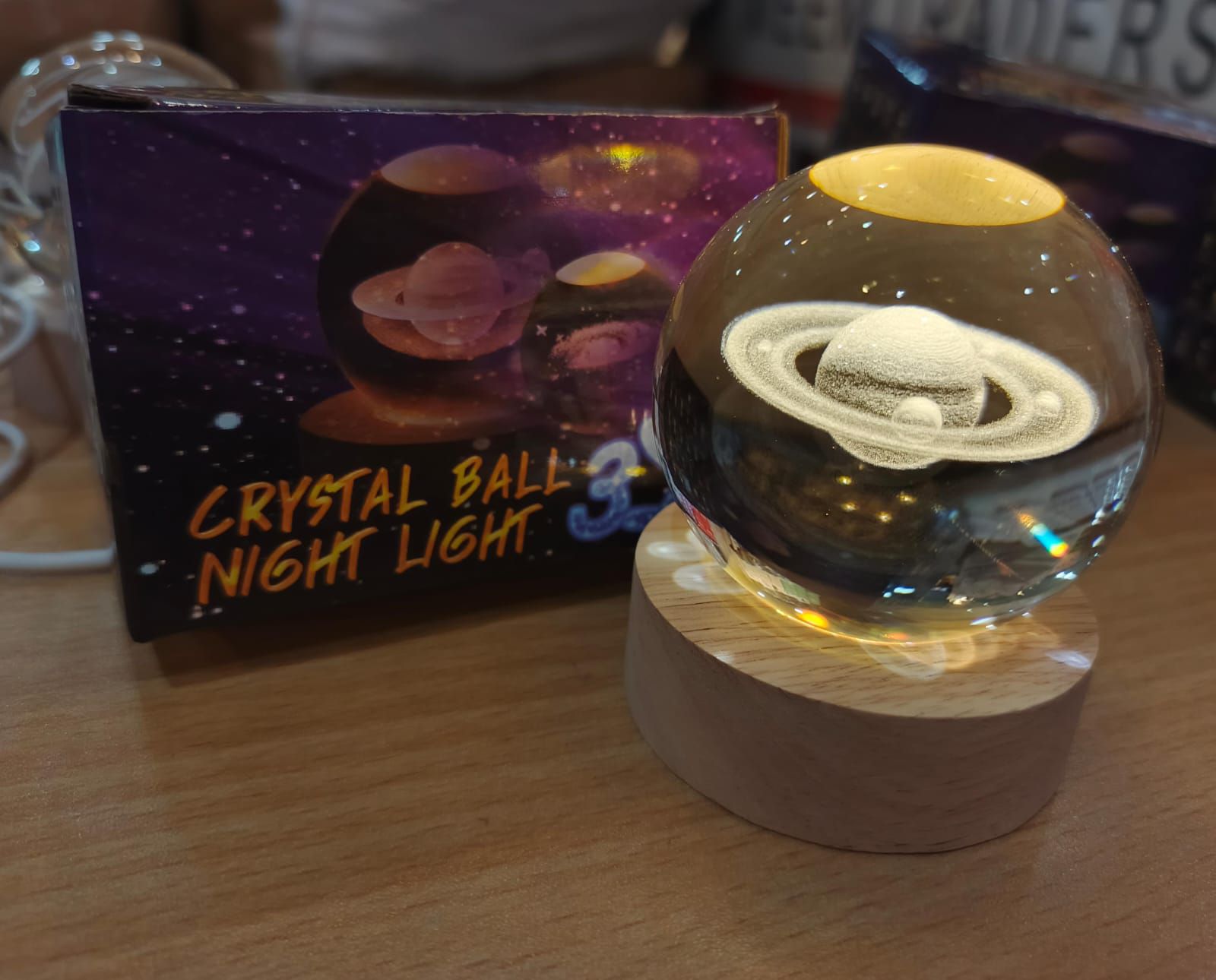Beautiful 3D Crystal Ball LED Table Lamp With Laser Engraved Solar System Or Galaxy Design On Wooden Base (Random Design)